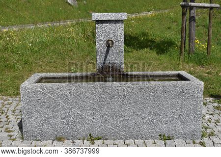 Water Is Flowing In A Fountain In Disentis In Switzerland 8.5.2020