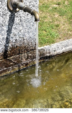 Water Is Flowing In A Fountain In Disentis In Switzerland 8.5.2020