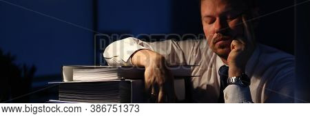 Portrait Of Smart Businessman Sitting Indoors And Closing Tired Eyes And Relaxing After Intense Tiri