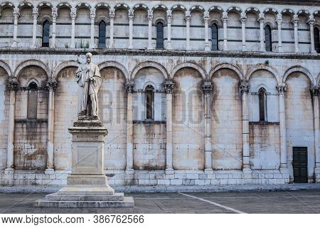 Lucca, Italy - July 9, 2017: View Of Francesco Burlamacchi Statue With San Michele In Foro Church In
