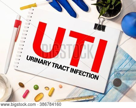 Uti Urinary Tract Infection Written In Notebook On White Table.