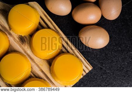Delicious Quindins On Wooden Board, Traditional Brazilian Dessert Made With Egg Yolk, Sugar And Coco