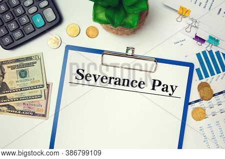 Paper With Severance Pay On The Table, Calculator And Glasses