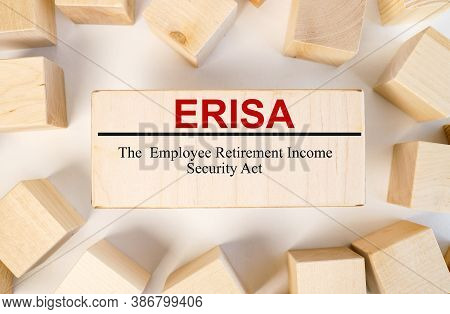 Erisa The Employee Retirement Income Security Act. Text On A Wooden Block On A Light Background Near