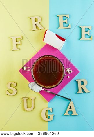 Cup Of Coffee And Pills Of Sugar Substitute And Natural Sweetener In Powder On A Purple Podium And T