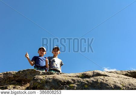 Two Small Children, Brothers Boys Standing On One Rocky Peak, A Mountain Of Carpathian Mountains, Ha