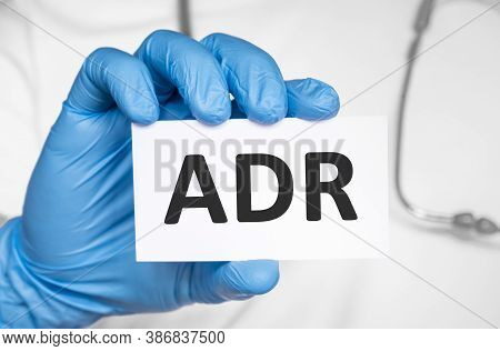 Doctor Holding A Card With Text Adr Adverse Drug Reaction, Medical Concept