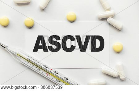 On White Business Card The Inscription Ascvd Atherosclerotic Cardiovascular Disease. Near Tablets An