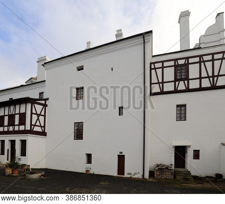 Detail Of Half Timbered White Walls With Some Doors And Windows Of Radim Castle