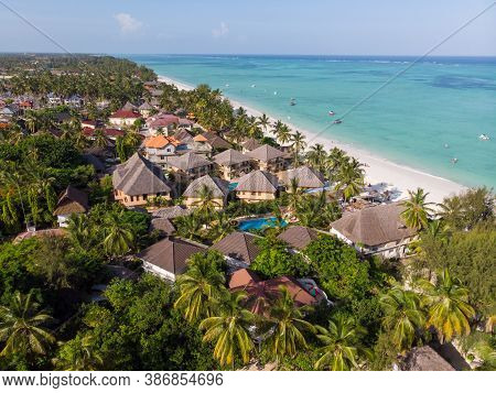 Aerial Shot Of A Luxury Hotel On A Beach First Line With Palm Trees Garden At Evening Time In Paje V