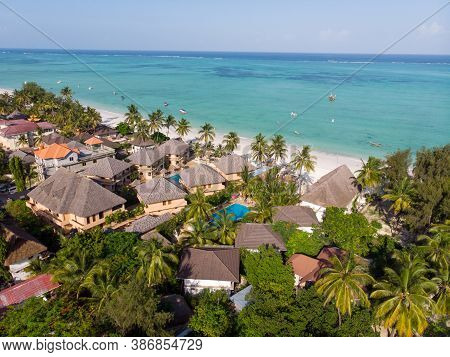 Aerial Shot Of A Luxury Hotel On A Beach First Line With Palm Trees Garden At Evening Time In Paje V