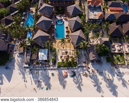 Aerial Shot Of A Luxury Hotel On A Beach First Line With Palm Trees Garden At Evening Time In Paje V