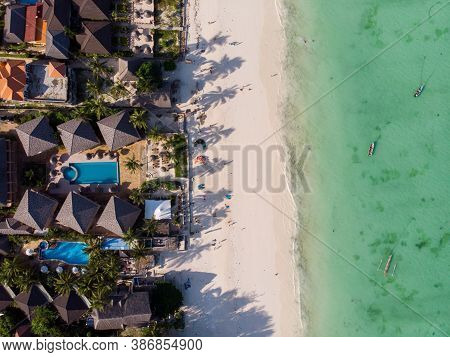 Aerial Shot Of A Luxury Hotel On A Beach First Line With Palm Trees Garden At Evening Time In Paje V