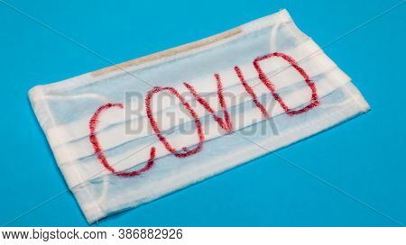 Typical White 3-ply Surgical Mask With Rubber Earhooks To Cover Mouth And Nose With English Block Le
