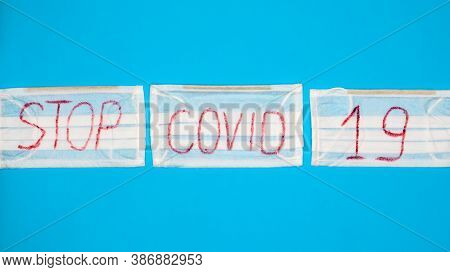 Typical 3-ply White Surgical Mask With Rubber Earhooks To Cover Mouth And Nose With English Block Le