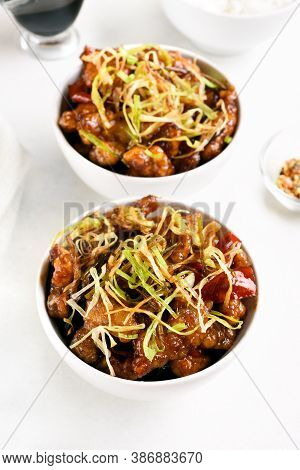Spicy Garlic Fried Chicken (kkanpunggi). Asian Chicken In Sweet And Sour Sauce In Bowl Over White Ba