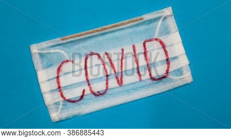 Typical White 3-ply Surgical Mask With Rubber Earhooks To Cover Mouth And Nose With English Block Le