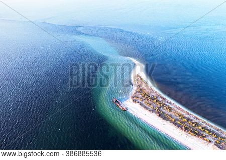 Old shipwreck reinforced concrete barge abandoned stand on beach on the coast of Black sea in Kinburn peninsula, Ukraine