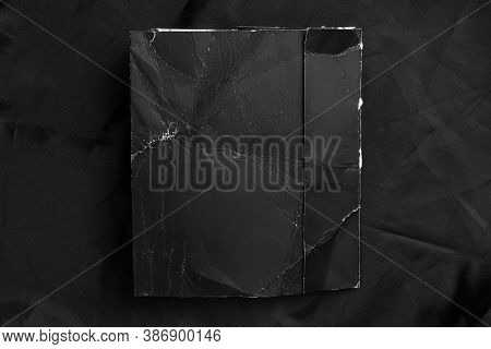 Black Wrinkled Paper With Frayed Folds On Black Wrinkled Synthetic Material. Close-up. Grunge Mock U