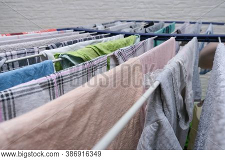 Fresh Washed Linen, Clothes Hanging On A Dryer, Dry Apparel On A Folding Portable Dryer Close Up, Ho
