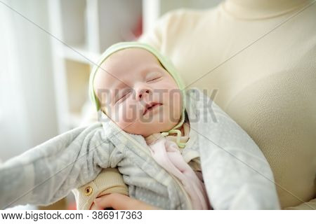 Newborn Baby Girl In Her Mother Arms. Newborn Baby Girl In Her Mother Arms. Baby Sleep Quietly Witou
