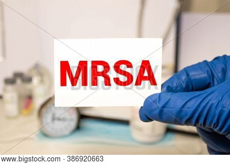 Doctors Hands In Blue Gloves Shows The Word Mrsa Methicillin-resistant Staphylococcus Aureus. Medica
