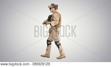 Armed Man In Camouflage With A Gun Walking On Gradient Backgroun