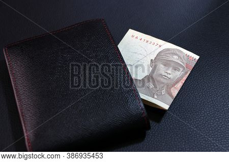 One Of Banknote Currency Myanmar Kyats With Black Wallet On The Black Floor. Obverse Side Portrait O