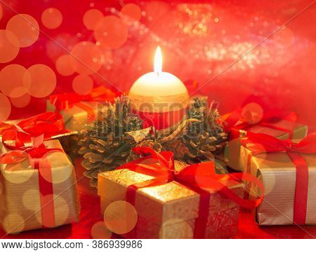 Burning Candle With Wrapped Gifts. Festive Christmas And New Yeat Background.