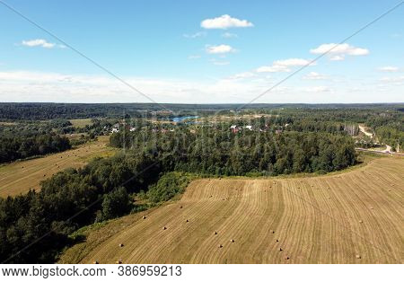 View From Drone To The Countryside Summer Fields With Many Rolled Haystacks And Forests Stretches To