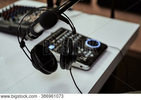 Working Place Of Radio Host. Close Up Of Headphones, Microphone And Sound Mixing Desk On The Table I