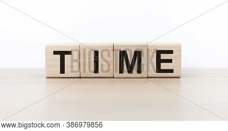 Wooden Cubes With The Inscription Time On The Table