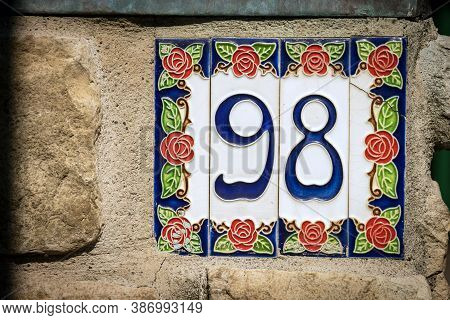Close-up Of House Number 98 (ninety Eight) On The Wall In A Small Village. Liguria, Italy, Europe