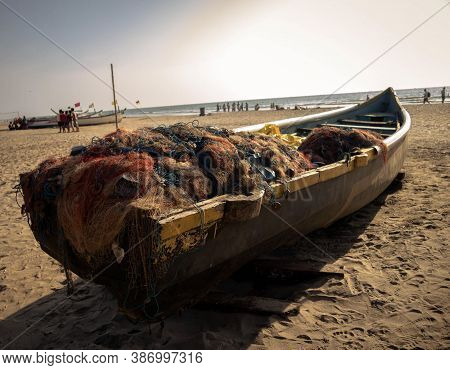 Picture Of A An Old Fishing Boat With Fishing Net Parked In A Beach In Goa