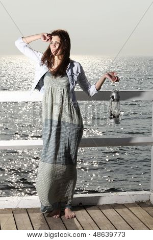 Girl On Pier With Kerosene Lamp
