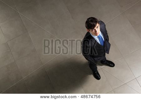 Image of young businessman looking above. Top view