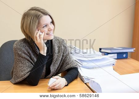 Office Worker Talking On Mobile Phone In The Workplace