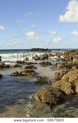 Beach with rocks and blue sky