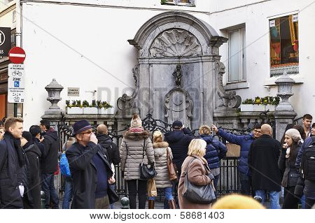 Brussels, Belgium - Fevrier 2:  Tourists Crowned In The Place Of The Manneken Pis Statue In Brussels