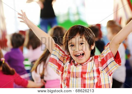 Children playing on colorful kindergarten playground