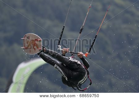 Professional  Kitesurfer Jumps Over The Water During Training On Lake Of Santa Croce