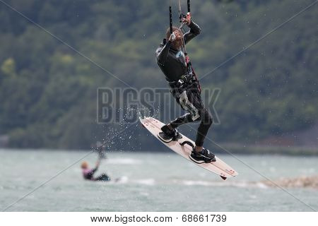 Professional  Kitesurfer Jumps Over The Water During Training On Lake Of Santa Croce