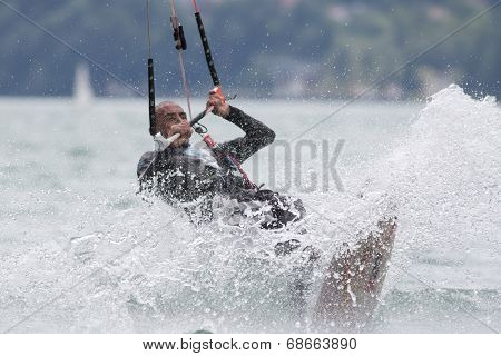 Professional  Kitesurfer Jumps Over The Water During Training On Lake Of Santa Croce