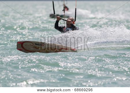 Professional  Kitesurfer Jumps Over The Water During Training On Lake Of Santa Croce