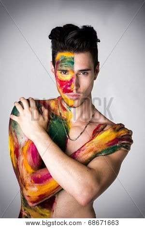Attractive Young Man Shirtless, Skin Painted All Over With Colors