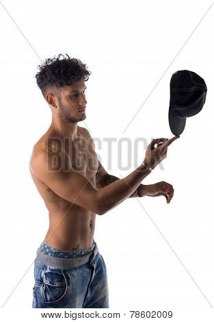 Trendy Young Man Balancing A Cap On His Finger