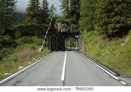 Mountain Road And Short Tunnel In Alps In Switzerland