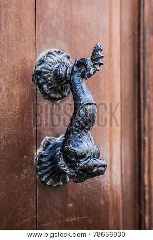 Old doorhandle in the form of an iron fish