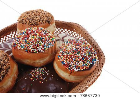 traditional jewish holiday chanuka donuts covered by dark chocolate on retro vintage basket isolated on white background