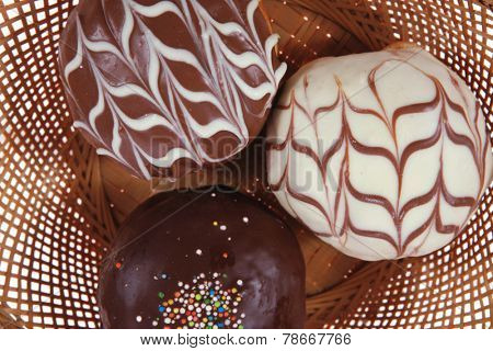 traditional jewish holiday chanuka donuts covered by dark chocolate on retro vintage basket isolated on white background